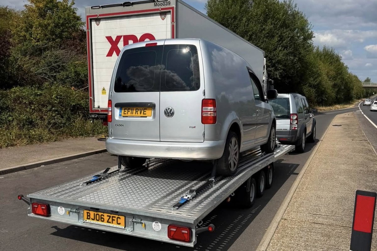 Silver Volkswagen Caddy transported on the tri-axle trailer