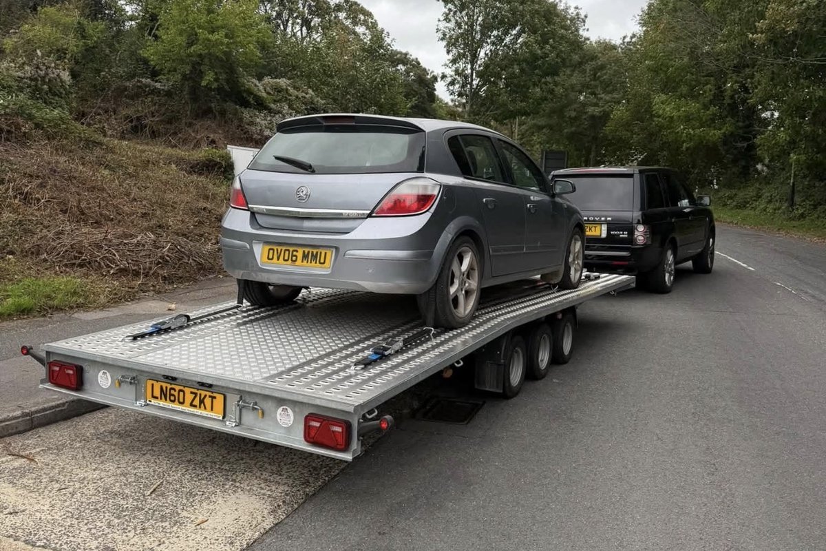 Silver Vauxhall Astra secured on the transporter trailer