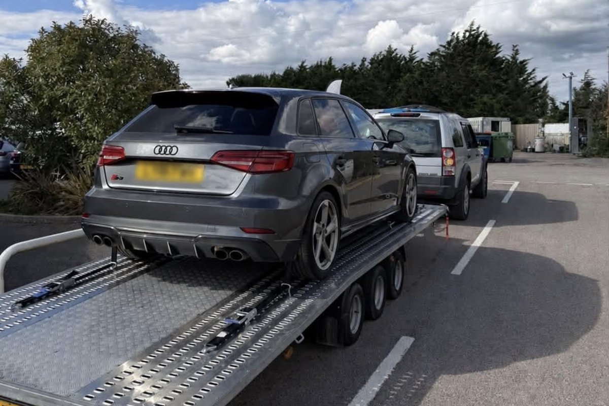 Grey Audi S3 loaded on the tri-axle transporter trailer
